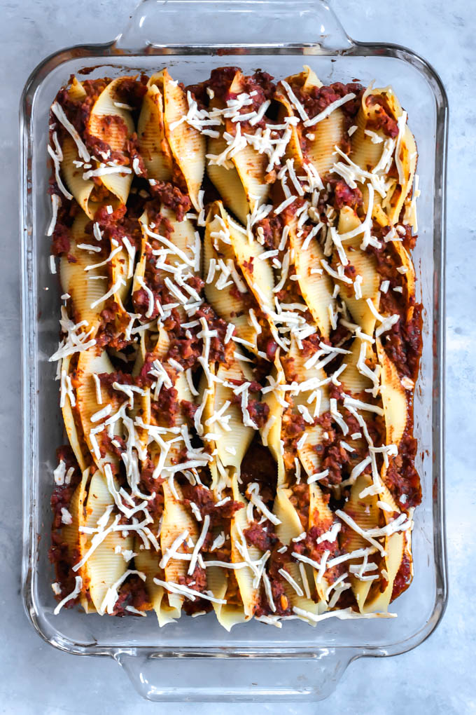 These Vegan Lasagna Stuffed Shells will be your family's go-to comfort food dinner! The shells are stuffed with tofu ricotta and a plant-based, meaty tomato sauce.