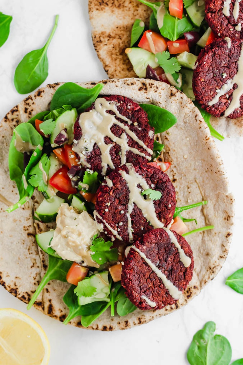 flat lay pita with pink beet falafel and tahini sauce