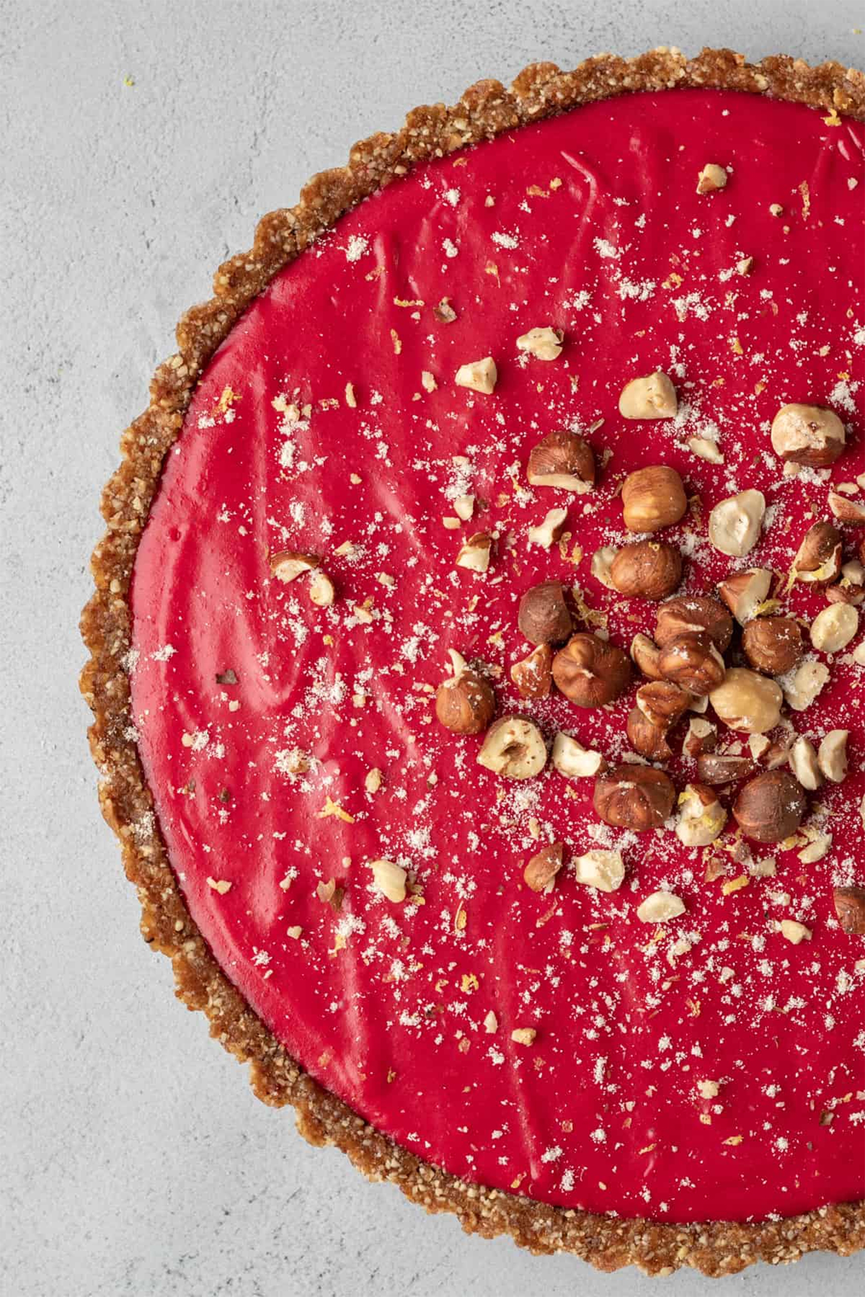 a cranberry tart toped with chopped hazelnuts