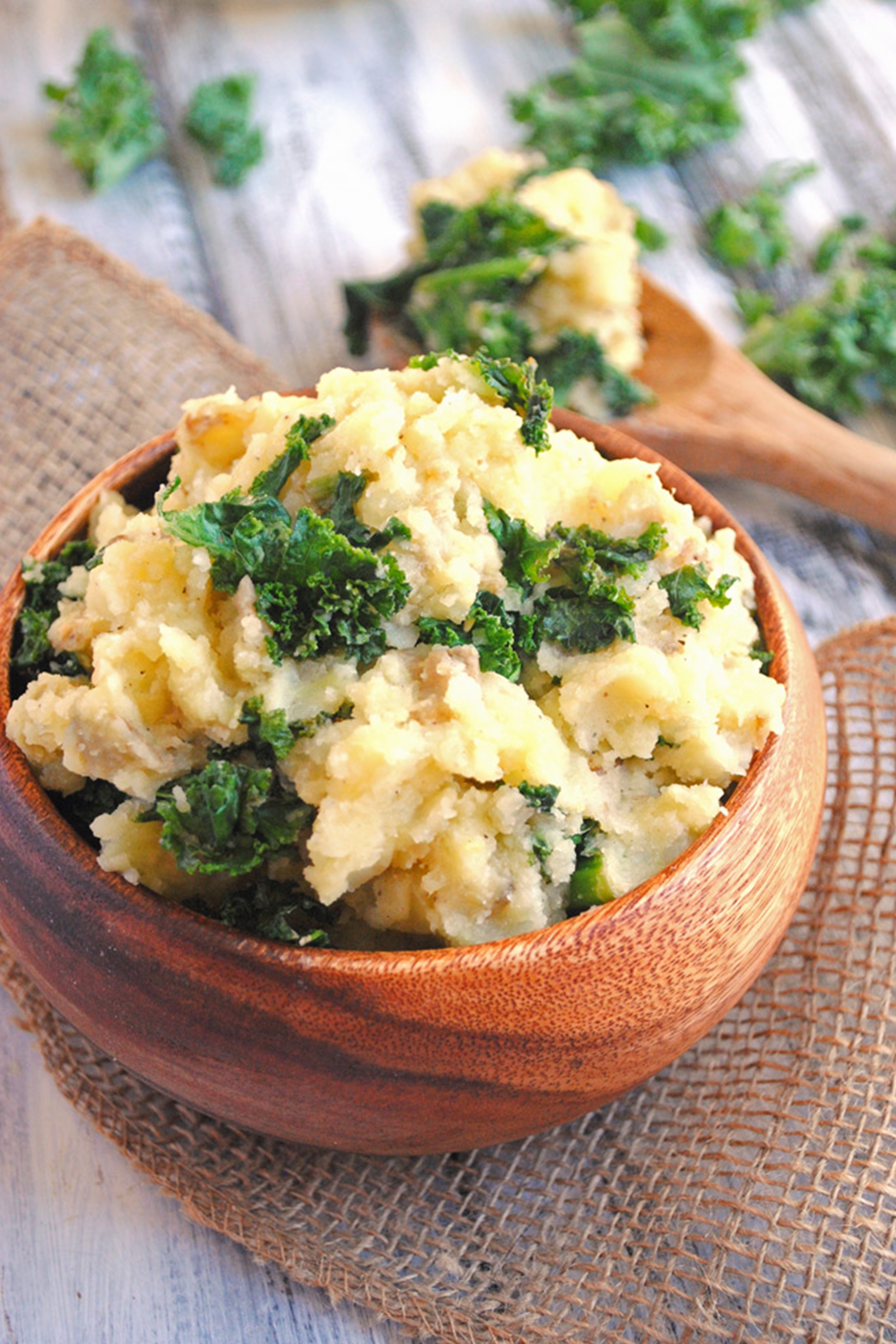 a bowl filled with mashed potatoes and kale